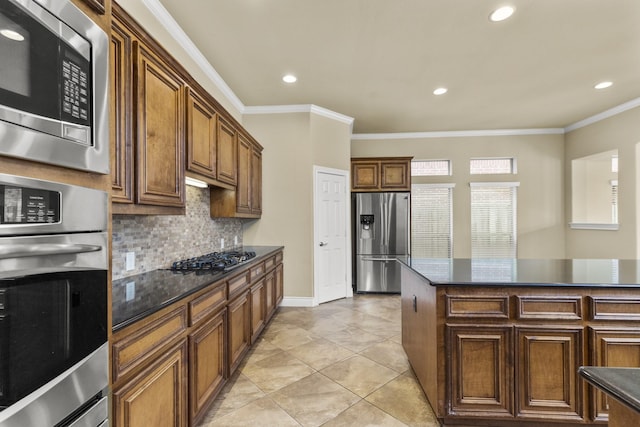 kitchen with recessed lighting, stainless steel appliances, baseboards, decorative backsplash, and crown molding