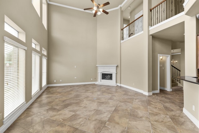 unfurnished living room with stairway, ceiling fan, baseboards, and a fireplace with raised hearth