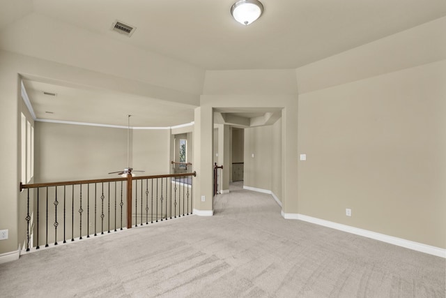 spare room with baseboards, visible vents, ceiling fan, and carpet flooring