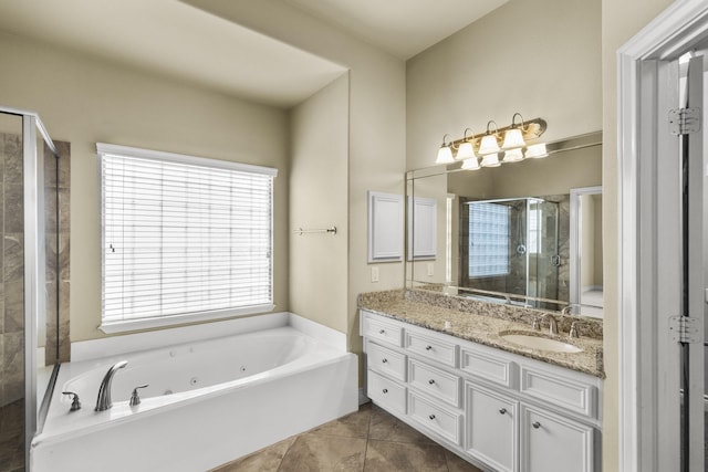 full bath with a tub with jets, a stall shower, vanity, and tile patterned floors