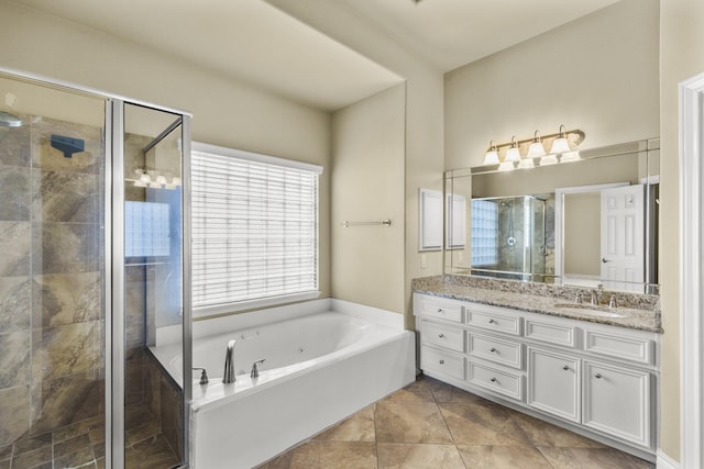 full bathroom featuring a whirlpool tub, a shower stall, and vanity