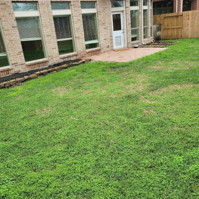 view of yard featuring fence and a patio