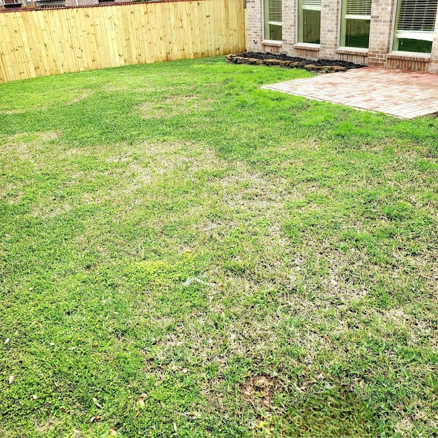 view of yard with a patio area and fence