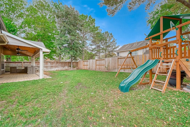 view of yard featuring a fenced backyard, a ceiling fan, a playground, and a patio