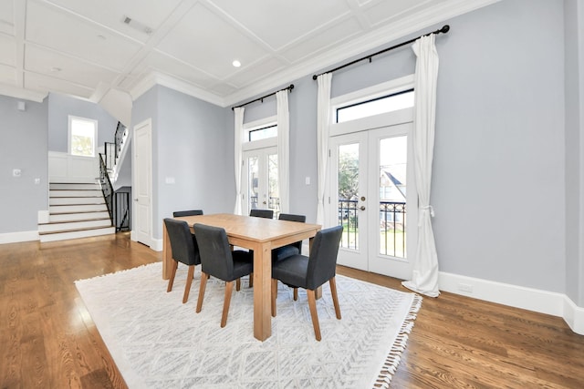 dining space with baseboards, coffered ceiling, stairway, wood finished floors, and french doors