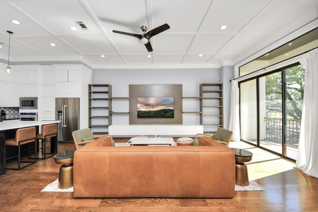 living room featuring recessed lighting, wood finished floors, visible vents, a ceiling fan, and ornamental molding