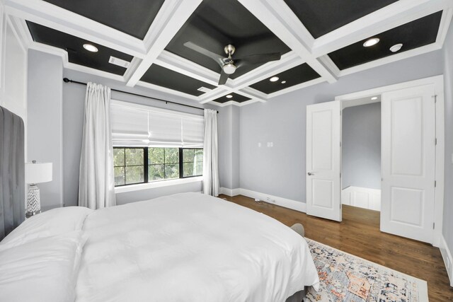 bedroom with dark wood-type flooring, coffered ceiling, and beam ceiling