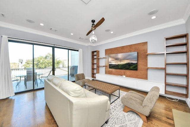 living area featuring ornamental molding, visible vents, and light wood finished floors