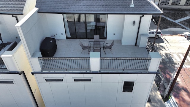 view of patio featuring a balcony