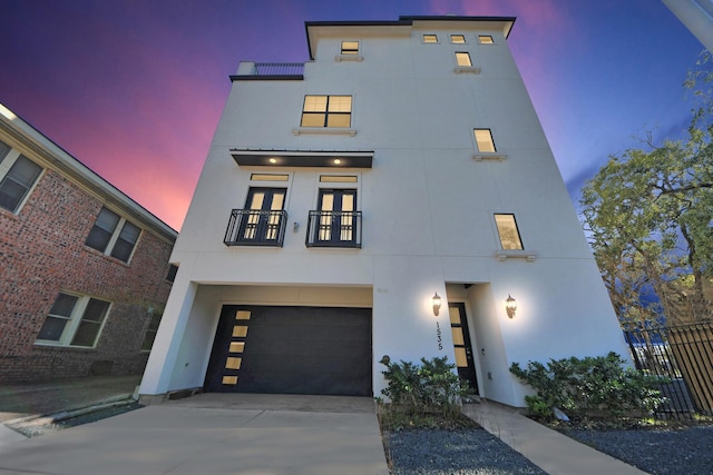 view of front of home featuring a garage, driveway, and stucco siding