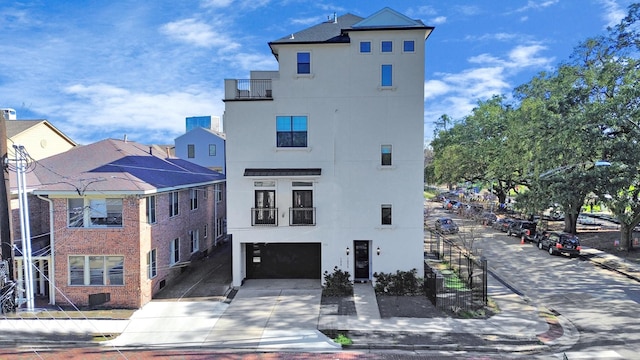 view of building exterior featuring driveway and a garage