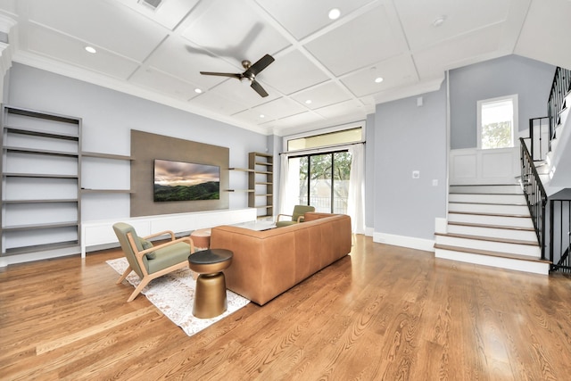 living area with light wood finished floors, stairs, and coffered ceiling