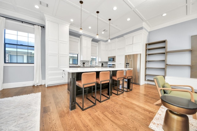 kitchen featuring pendant lighting, light countertops, visible vents, appliances with stainless steel finishes, and white cabinetry