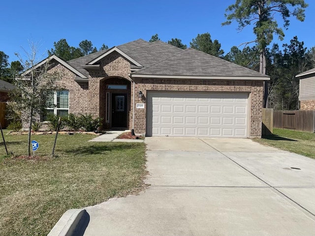 single story home with a front yard, brick siding, fence, and driveway