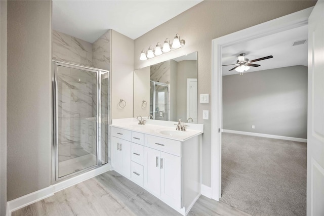 bathroom with baseboards, a sink, and a shower stall