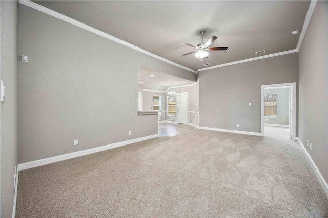 spare room with visible vents, ornamental molding, a ceiling fan, light carpet, and baseboards