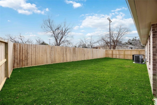 view of yard featuring a fenced backyard and central AC unit