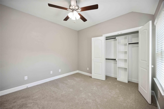 unfurnished bedroom featuring carpet floors, a ceiling fan, baseboards, and a closet