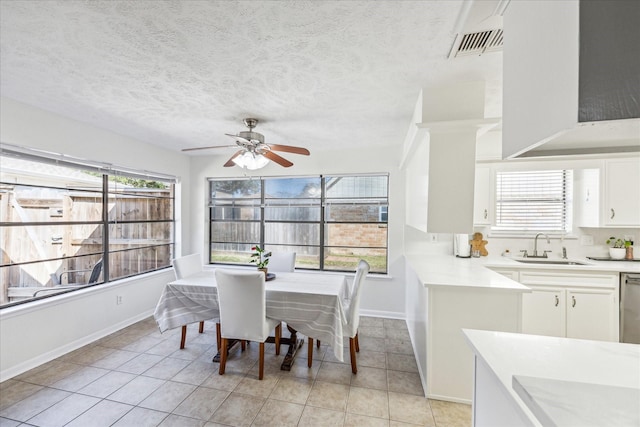 dining space with a wealth of natural light, visible vents, and light tile patterned flooring