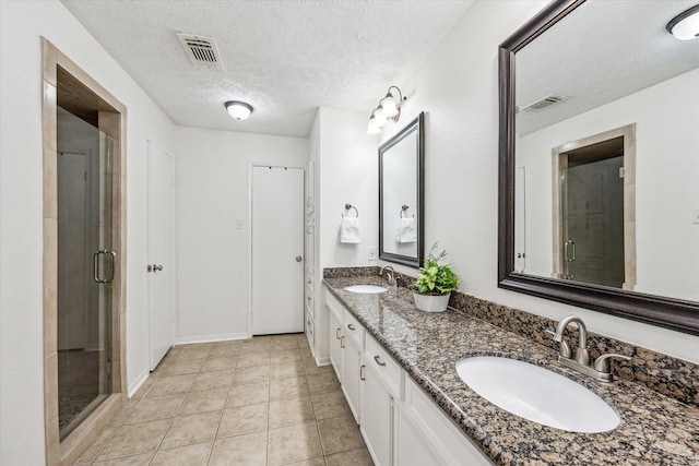 full bath with double vanity, a sink, and visible vents