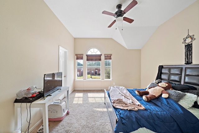 bedroom featuring light colored carpet, vaulted ceiling, baseboards, and ceiling fan