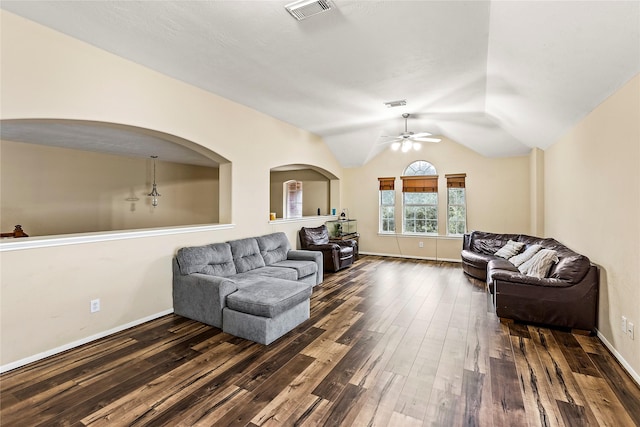 living room featuring dark wood-style floors, visible vents, vaulted ceiling, and baseboards