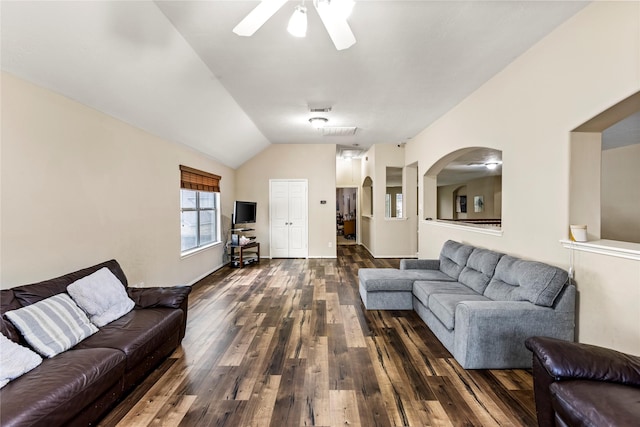 living area with vaulted ceiling, dark wood-type flooring, arched walkways, and a ceiling fan