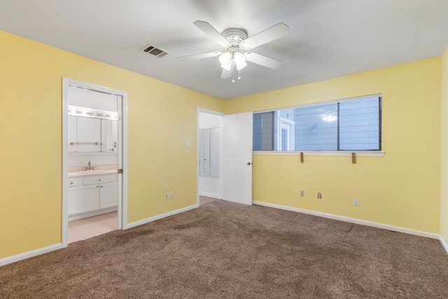 10 April Point Dr S Unit 10, Conroe, TX 77356 - unfurnished bedroom with a sink, light colored carpet, baseboards, ensuite bath, and ceiling fan