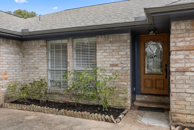 814 Pickford Dr, Katy, TX 77450 - doorway to property featuring roof with shingles and brick siding