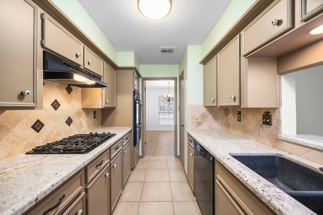 814 Pickford Dr, Katy, TX 77450 - kitchen featuring black appliances, under cabinet range hood, a chandelier, a textured ceiling, and light stone counters