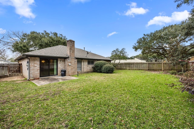814 Pickford Dr, Katy, TX 77450 - back of property with a fenced backyard, a patio, a chimney, a shingled roof, and brick siding