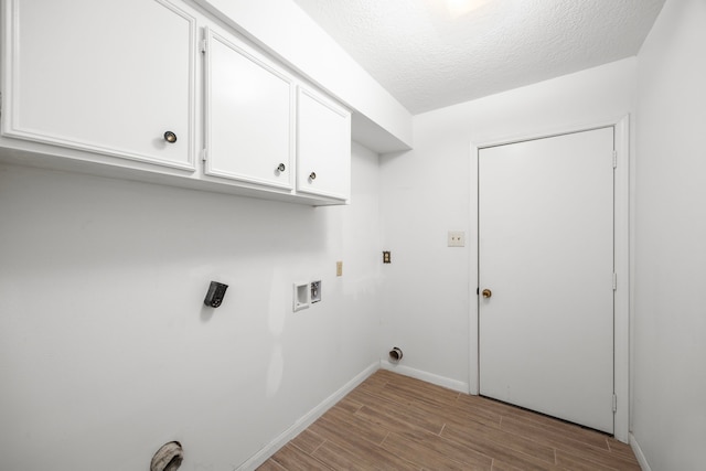 814 Pickford Dr, Katy, TX 77450 - washroom with wood finished floors, washer hookup, cabinet space, and a textured ceiling