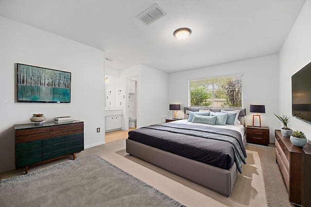 814 Pickford Dr, Katy, TX 77450 - carpeted bedroom featuring ensuite bathroom and baseboards