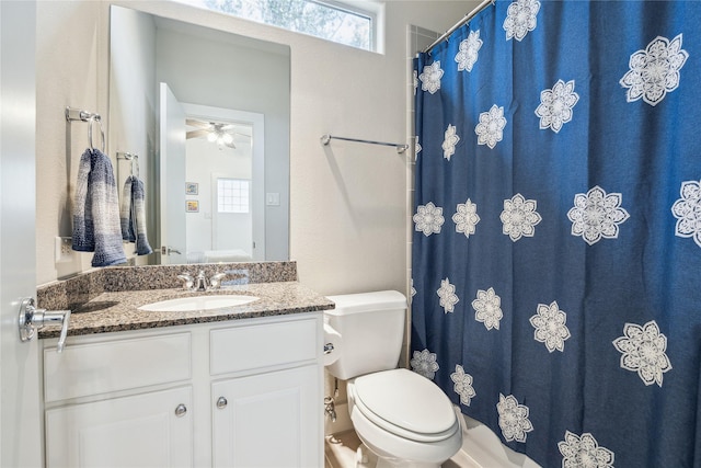 bathroom featuring toilet, a ceiling fan, and vanity