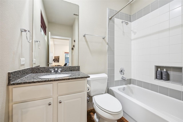 full bathroom featuring shower / bath combination, visible vents, a textured wall, toilet, and vanity