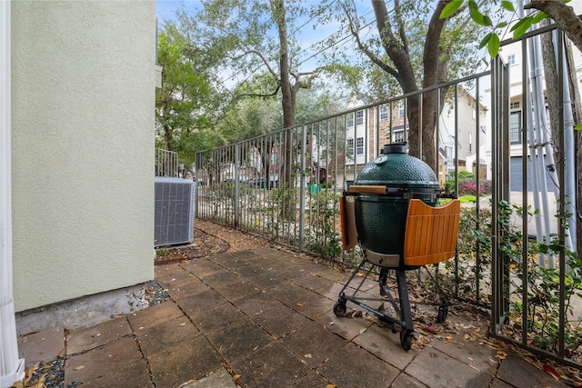 view of patio with fence and central AC unit