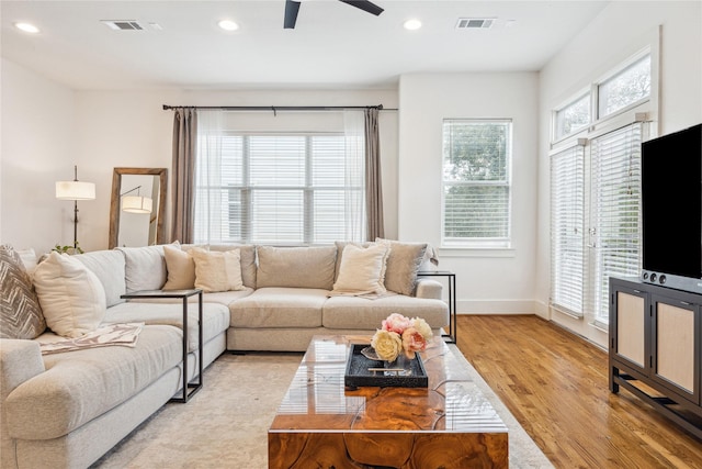 living area with recessed lighting, baseboards, visible vents, and light wood finished floors