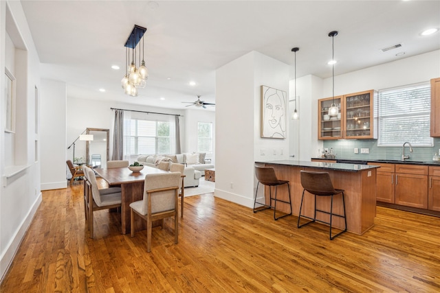 dining room featuring recessed lighting, visible vents, baseboards, and wood finished floors