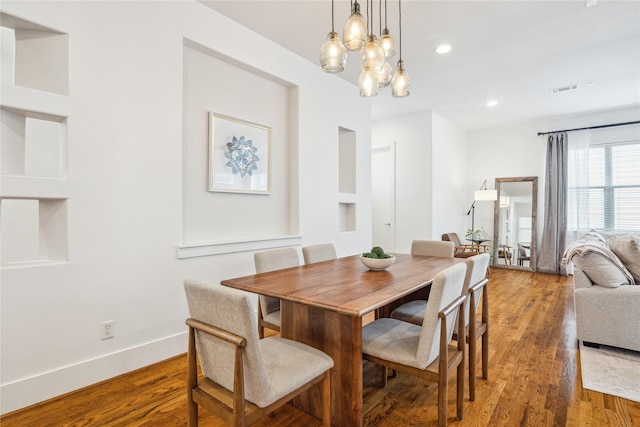 dining area with recessed lighting, visible vents, wood finished floors, a chandelier, and baseboards