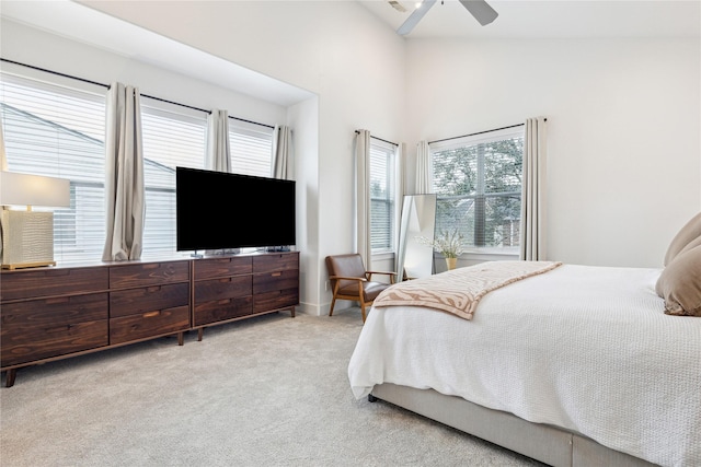 bedroom with light carpet, high vaulted ceiling, and a ceiling fan