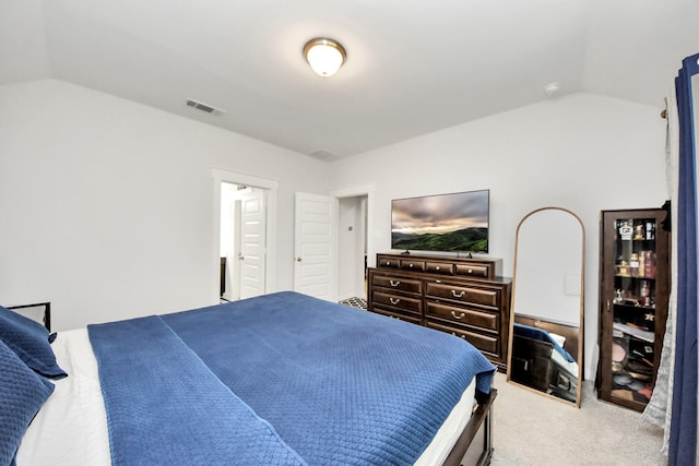 bedroom with vaulted ceiling, carpet flooring, and visible vents