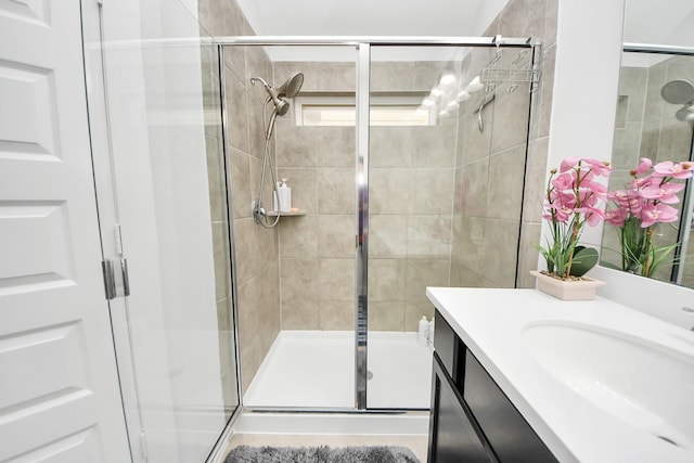 bathroom with a stall shower and vanity