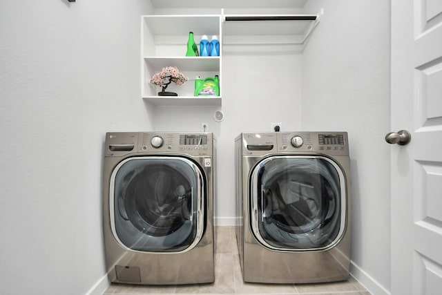 washroom with laundry area, independent washer and dryer, and baseboards