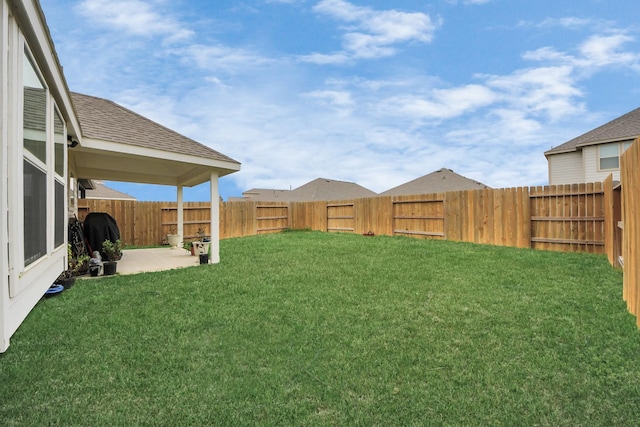 view of yard with a fenced backyard and a patio