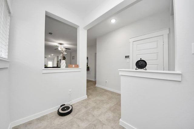 interior space with visible vents, baseboards, and a ceiling fan