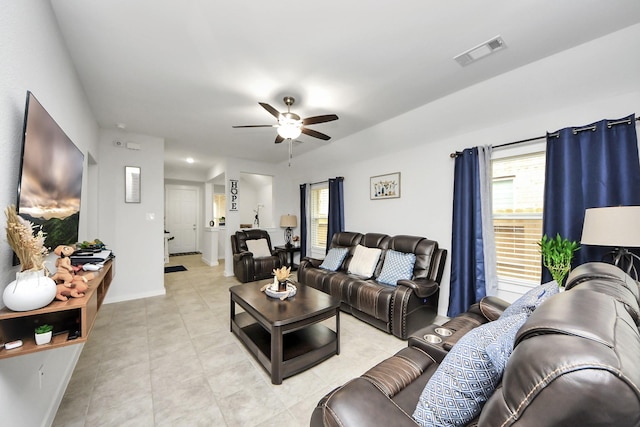 living room featuring visible vents, ceiling fan, baseboards, and light tile patterned floors