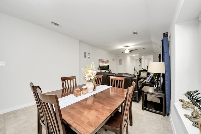 dining area featuring ceiling fan, light tile patterned floors, visible vents, and baseboards