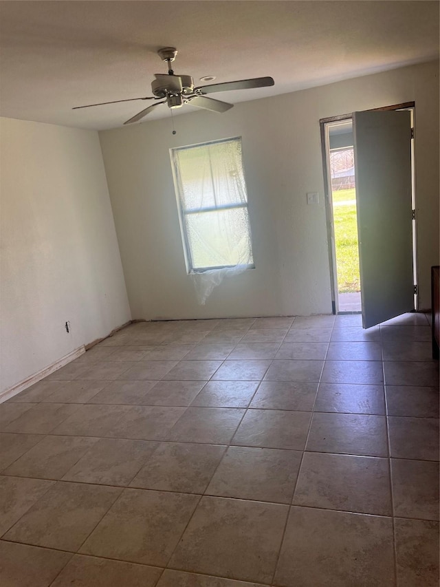 empty room featuring ceiling fan and light tile patterned floors