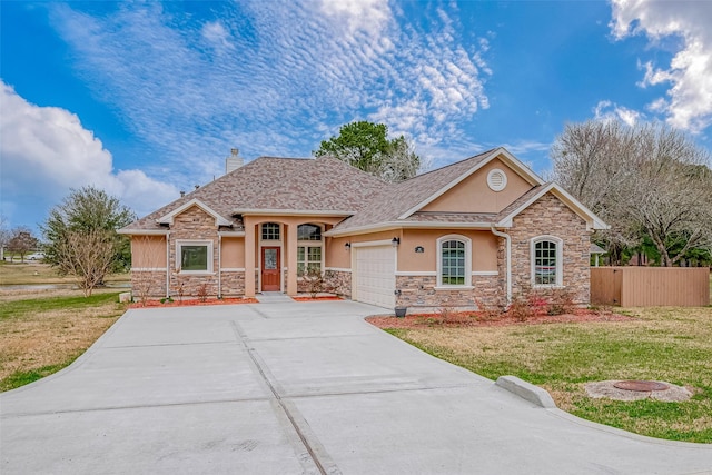 view of front facade with a chimney, stucco siding, an attached garage, driveway, and a front lawn