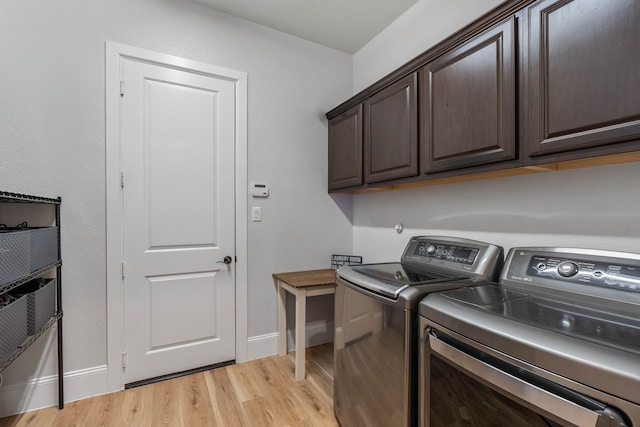 laundry room with light wood-style floors, cabinet space, independent washer and dryer, and baseboards